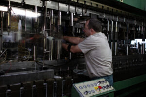 Side view of a stamping press bay with a die changeover in progress, illustrating the tooling transitions common to automotive takeover work